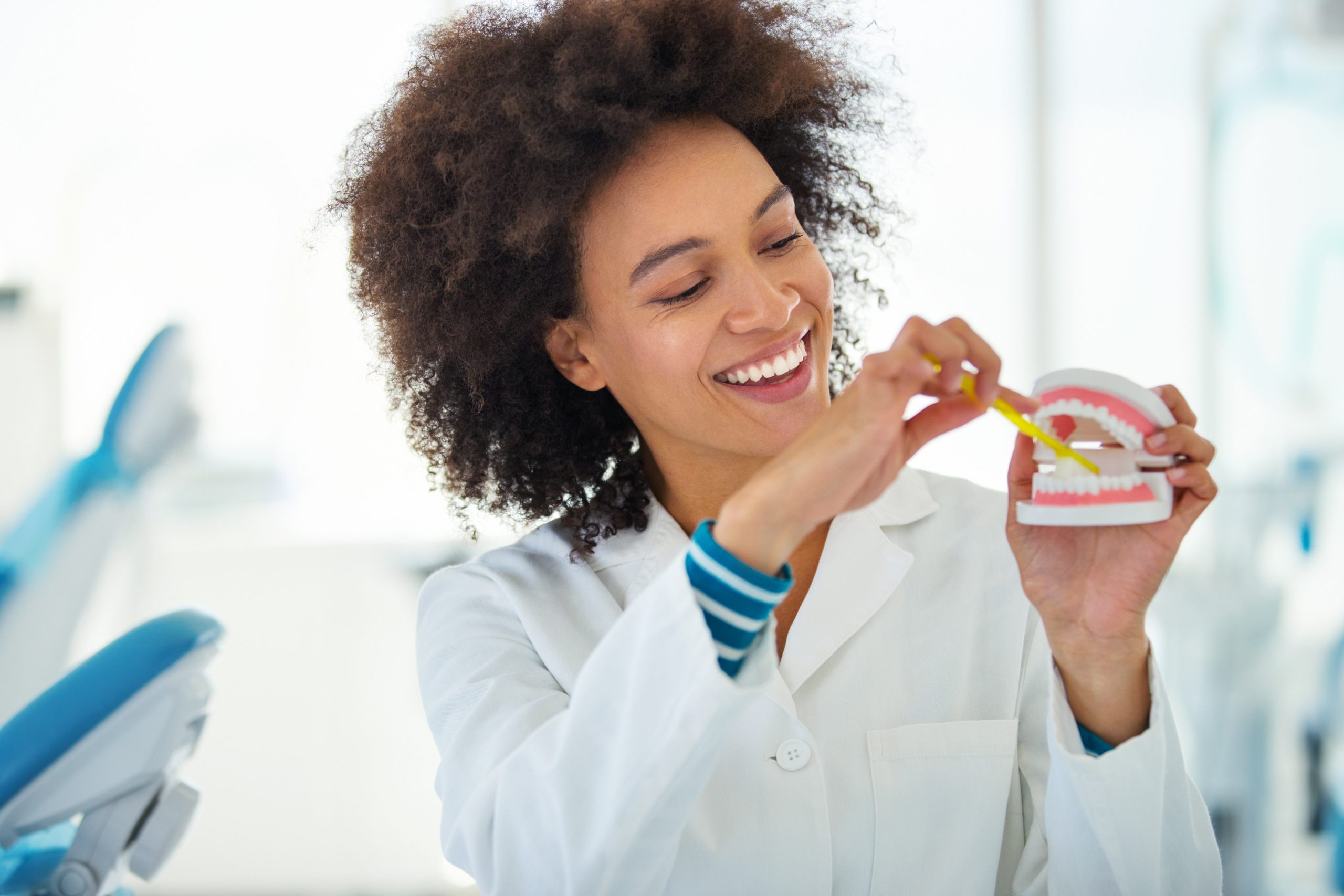 Hygienist Showing The Proper Way Of Brushing Teeth.