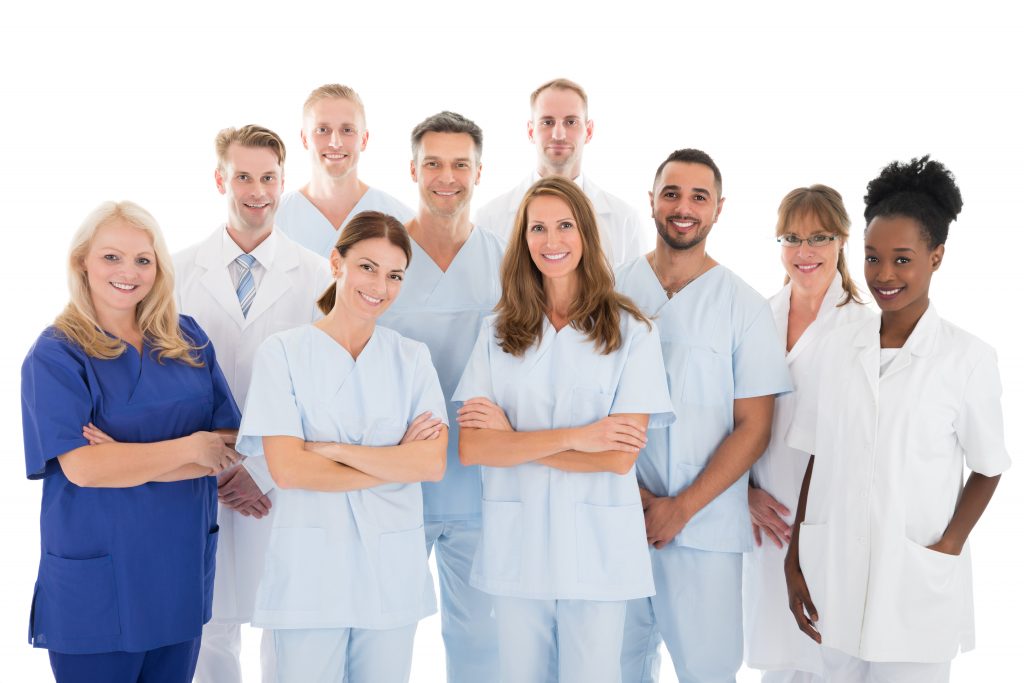 Happy Dental Team Standing Against White Background